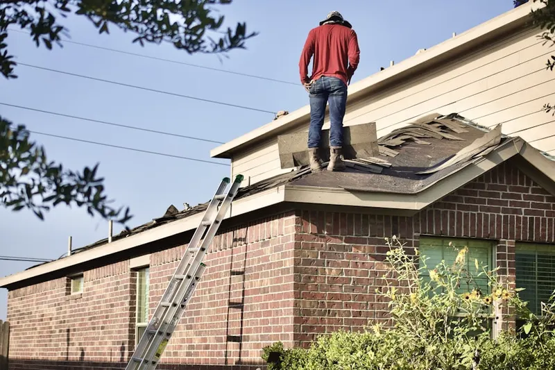 Professional roofer working on a residential roof in Skyview